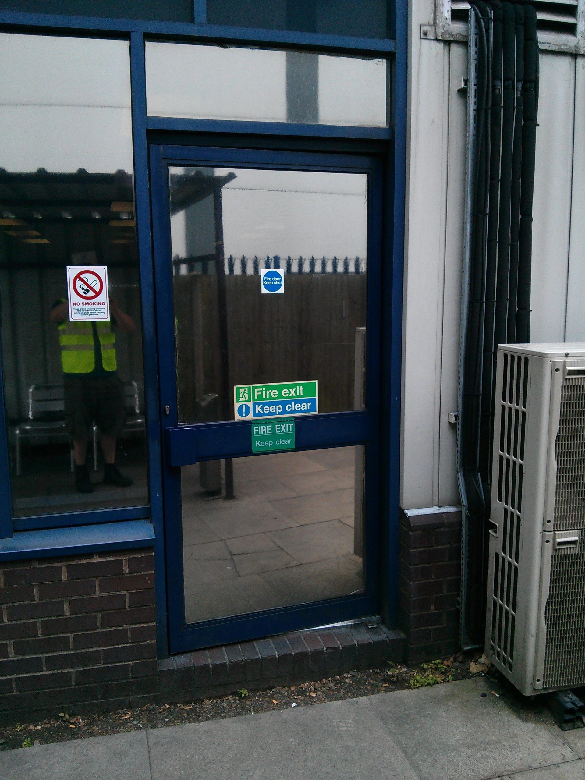 Blue aluminium commercial fire door recently repaired by CODORE